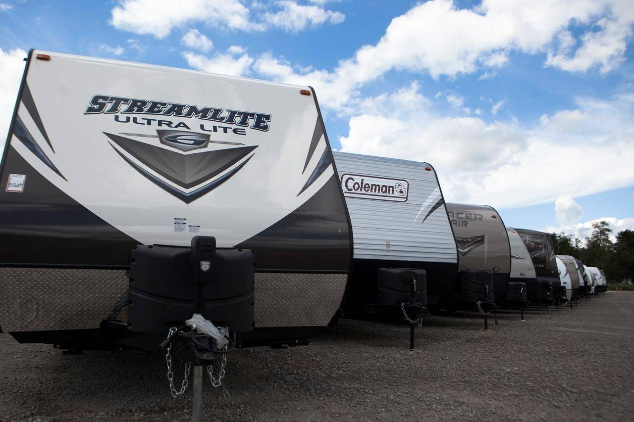 Recreational vehicles sit in a lot waiting for delivery at Horizon Transport in Wakarusa, Ind. on July 15, 2014. RV delivery is a growing trend that allows travelers to enjoy all of the conveniences of staying in an RV without actually having to drive it. Several companies offer delivery services for customers who rent, which can not only be more convenient, but also more affordable. (James Buck/The Elkhart Truth via AP)