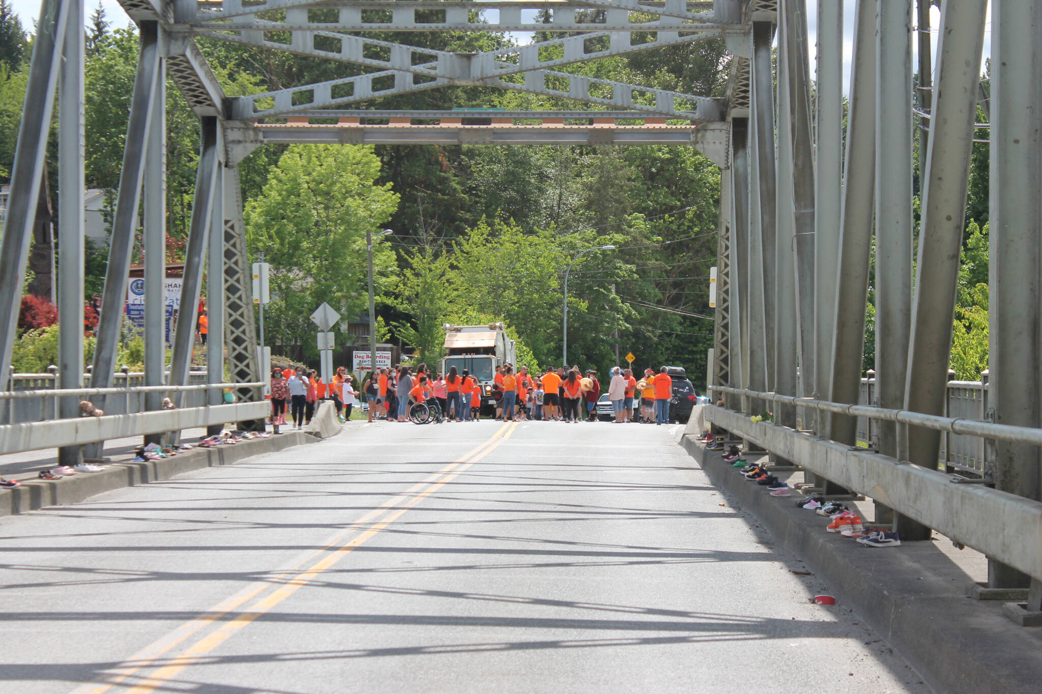 A group of people in orange shirts gathers on Pacific Rim Highway on the Tseshaht First Nation reserve. (PHOTO COURTESY TSESHAHT FIRST NATION)