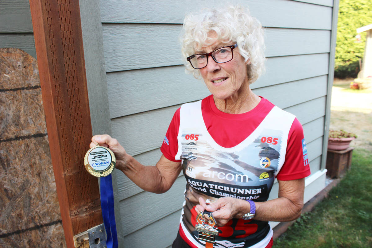 Janis German with her mementoes from the AquaticRunner Individual World Championship in Italy. (Photo by Don Bodger)
