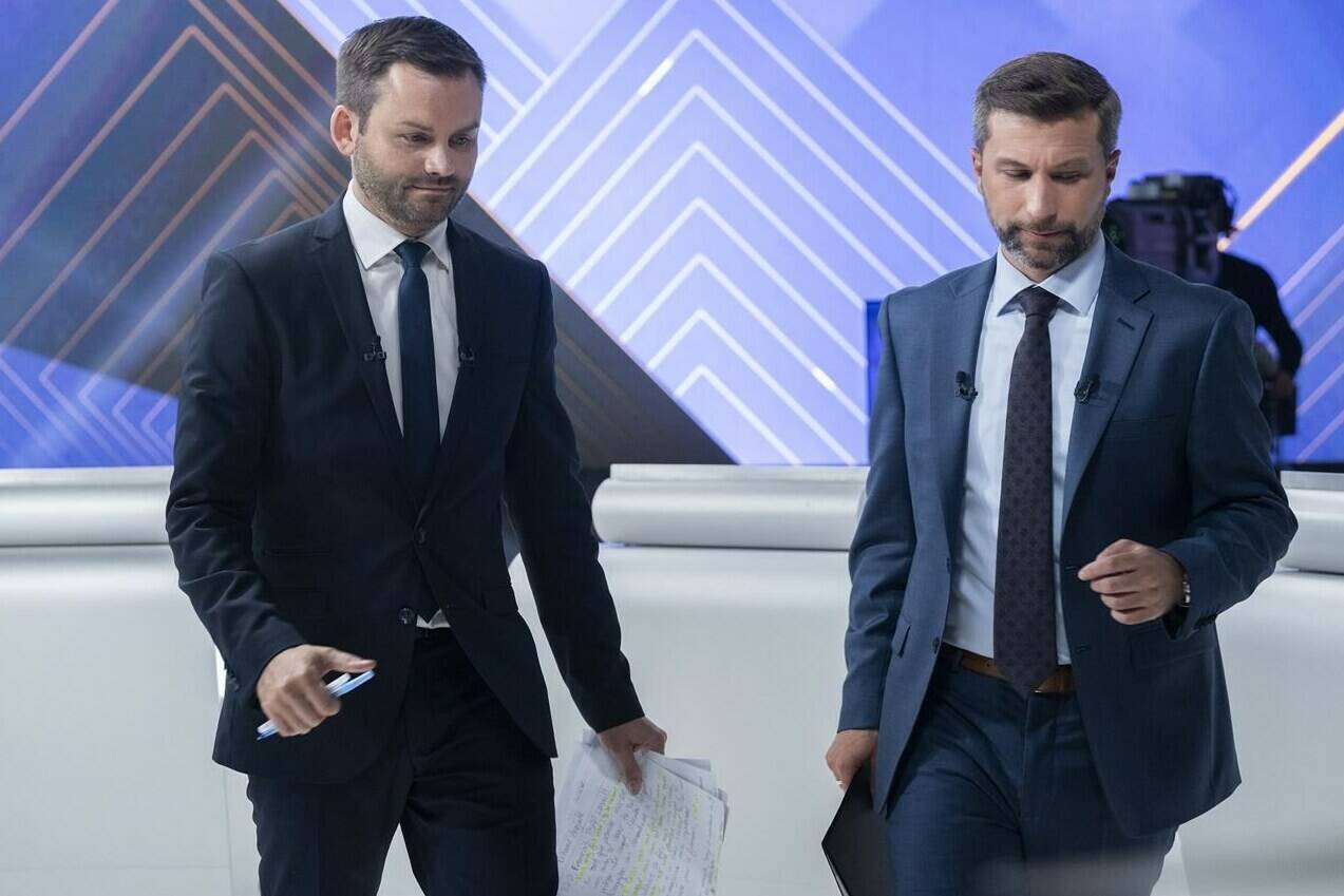 Parti Québécois Leader Paul St-Pierre Plamondon, left, and Québec solidaire co-spokesperson Gabriel Nadeau-Dubois walk off set following a leaders debate in Montreal, Thursday, Sept. 22, 2022. THE CANADIAN PRESS/Paul Chiasson