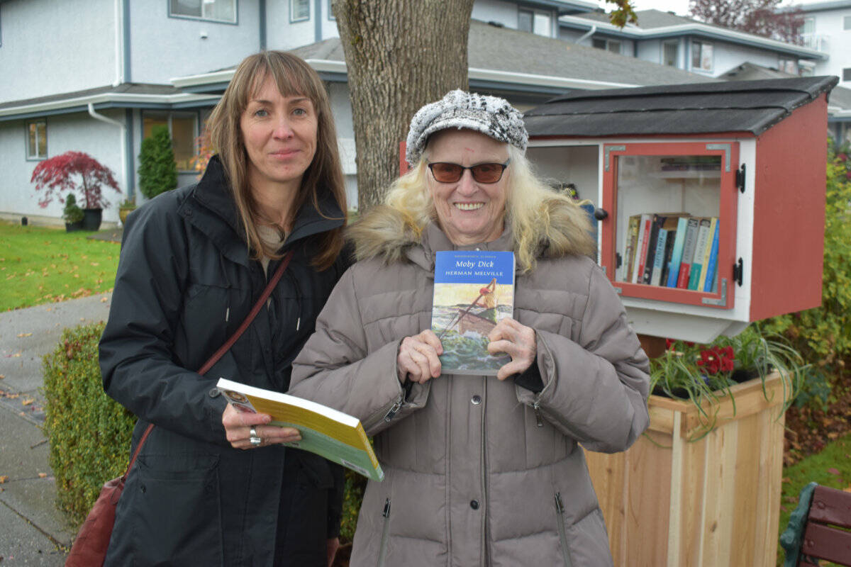 Shantael Sleight, outreach co-ordinator with the Saanich Peninsula Literacy Society, and Wakefield Manor resident Geri Holland, stand next to the new little free library that opened on Third Street in Sidney. (Wolf Depner/News Staff)
