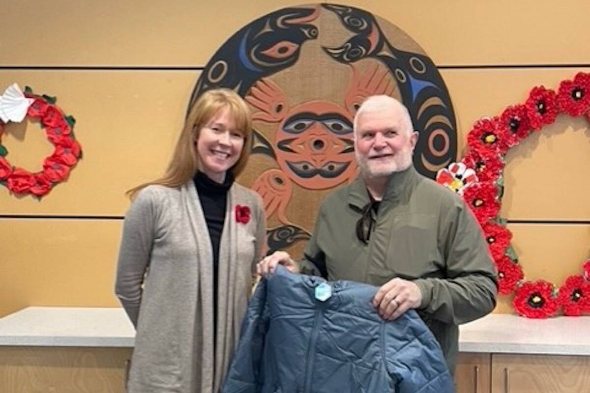 KELSET Elementary School principal Tassie Harris (left) and Knights of Columbus Sidney trustee Joe Bourdeau with a jacket the group gave to a student at the school. (Courtesy of Joe Bourdeau)