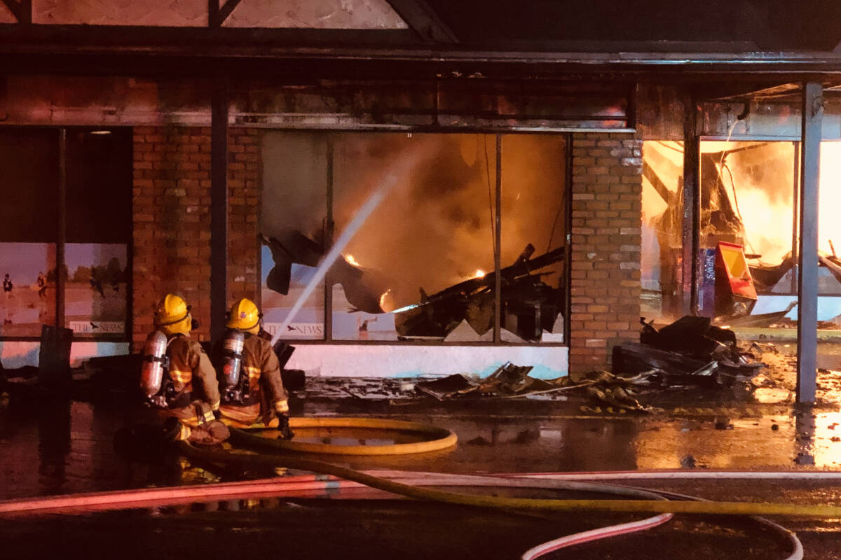 Firefighters hose down the PQB News offices on Wednesday, Nov. 9. (Michael Briones photo)