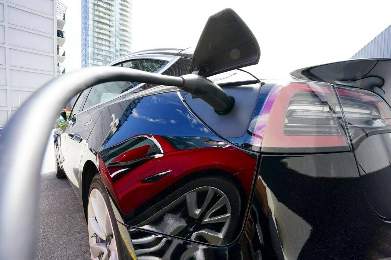 An electric vehicle is charged in Ottawa on Wednesday, July 13, 2022. Electric vehicle sales in Canada grew by more than one-third in the first half of this year but they're not keeping pace with the rest of the world. THE CANADIAN PRESS/Sean Kilpatrick