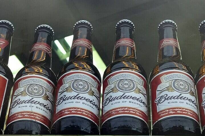 FILE - Bottles of Budweiser beer are on display in a shop window in London on Oct. 13, 2015. World Cup organizers reportedly have made another late change in alcohol policy only two days before games start in Qatar by banning beer sales at the eight soccer stadiums in and around Doha. Media reports say Qatari authorities are pressing FIFA to ban all sales of long-time World Cup beer sponsor Budweiser at the eight venues. (AP Photo/Kirsty Wigglesworth, File)