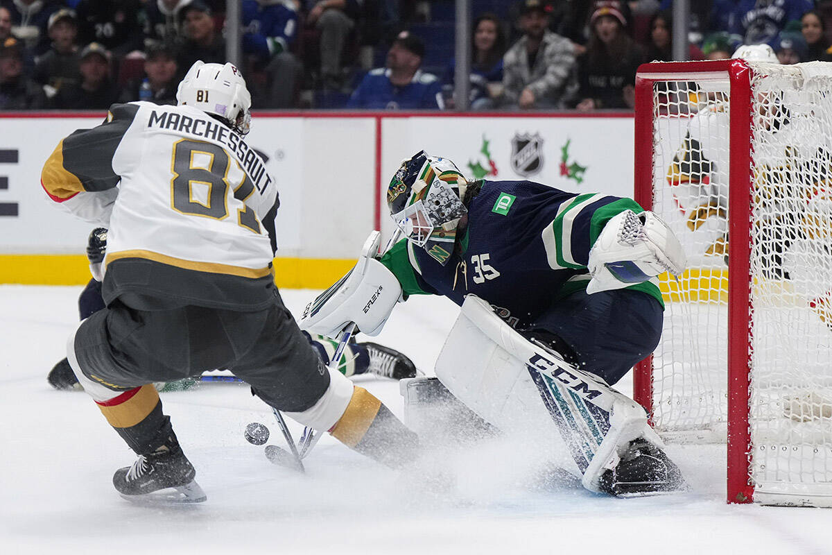 Vancouver Canucks goalie Thatcher Demko, right, stops Vegas Golden Knights’ Jonathan Marchessault during first period NHL hockey action in Vancouver, B.C., Monday, Nov. 21, 2022. THE CANADIAN PRESS/Darryl Dyck