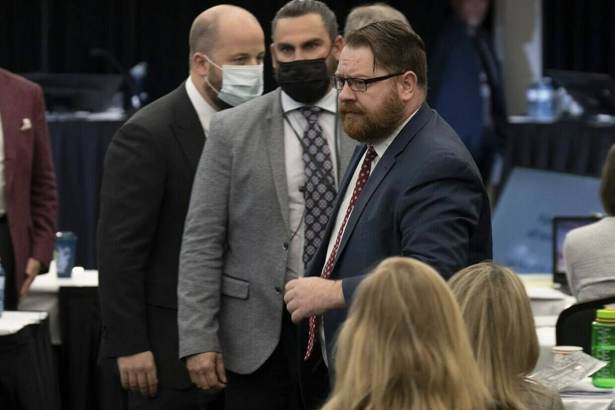 Security escort Freedom Corp. counsel Brendan Miller out of the hearing room at the Public Order Emergency Commission, in Ottawa, Tuesday, Nov. 22, 2022. Justice Paul Rouleau, the inquiry’s commissioner, asked security to remove Miller from the hearing after Miller spoke over the commissioner and accused him of refusing to rule on similar applications. THE CANADIAN PRESS/Adrian Wyld