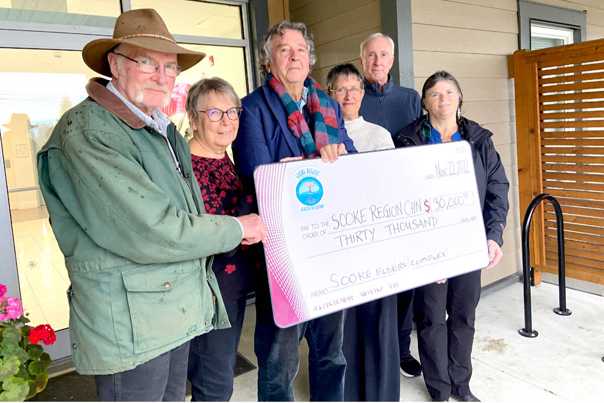 Devon Mills (left) and Linda Love of the Providence Valley Housing Society present a $30,000 cheque to Sooke Region Communities Health Network reps Andrew Moore, Annemieke Holthuis, Rick Robinson and Anne Bell. The money will be used to fund senior housing at The Gathering Place. (Kevin Laird – Sooke News Mirror)