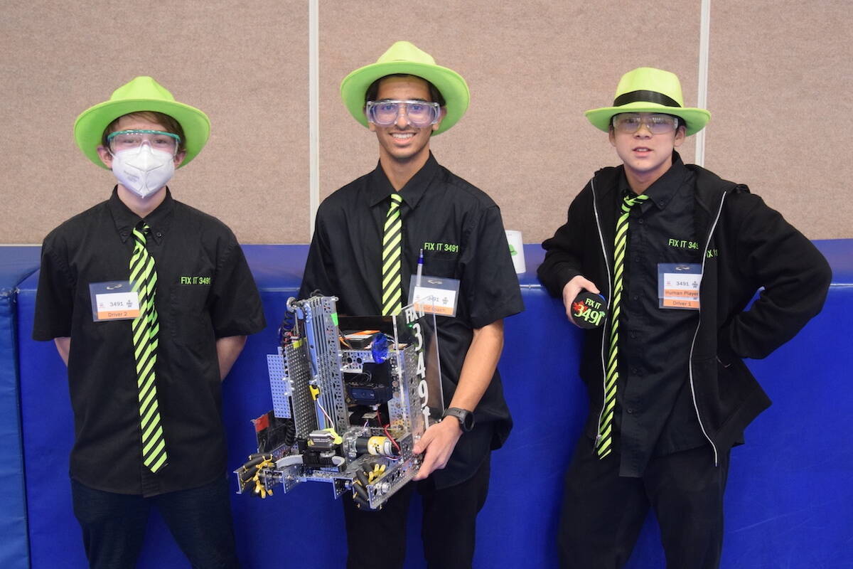 Community-based team FIX IT from Victoria featuring Kai Williams (from left), Amren Kareer and Bryce Kong prepares to compete at a FIRST Tech Challenge at St. Margaret’s School. (Brendan Mayer/News Staff)