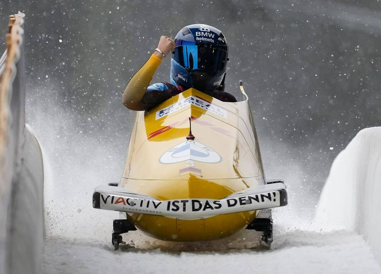 Germany’s Kim Kalicki, front, celebrates after she and Anabel Galander raced to a first-place finish during the two-woman bobsleigh competition at the IBSF BOB world cup event, in Whistler, B.C., on Saturday, Nov. 26, 2022. THE CANADIAN PRESS/Darryl Dyck