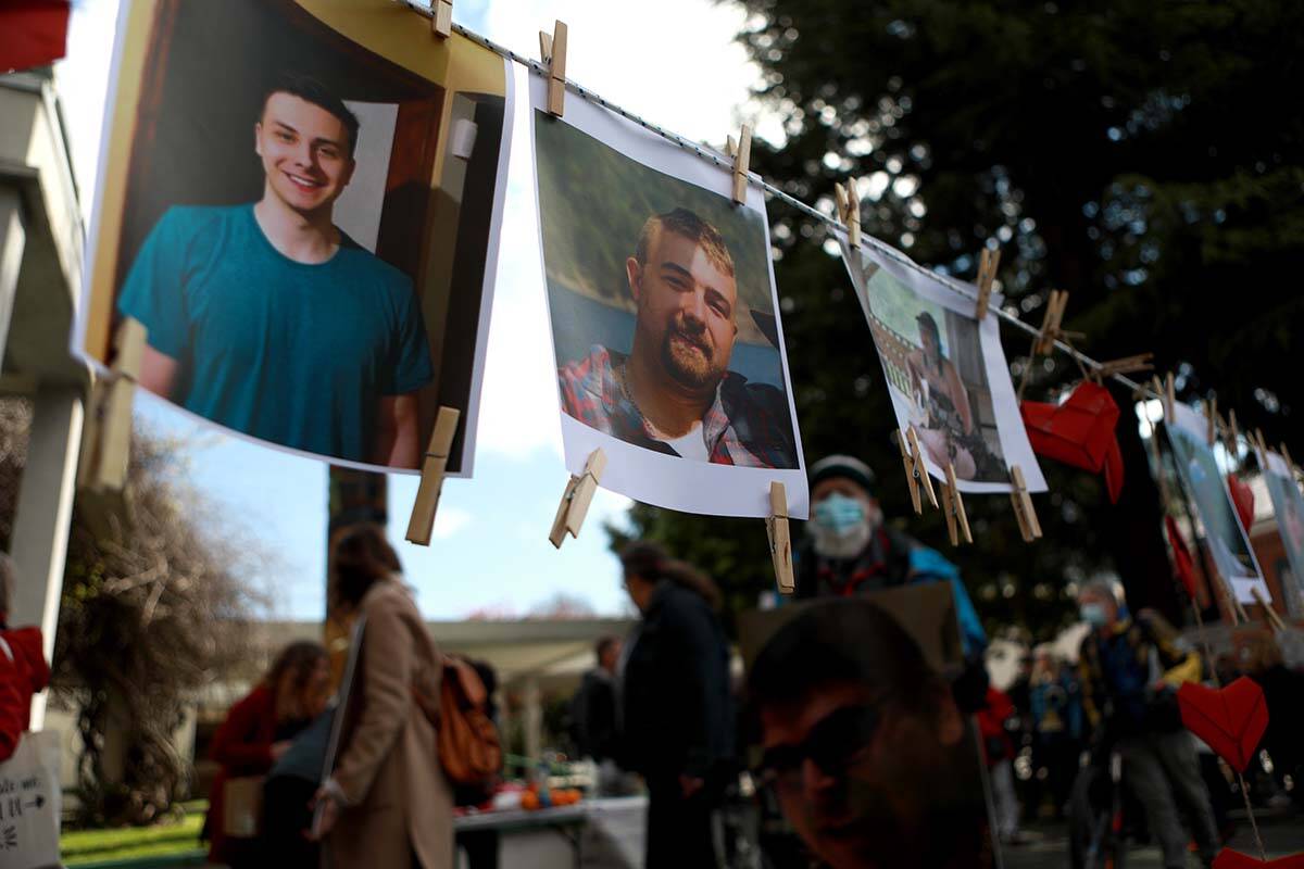 Moms Stop the Harm advocates and supporters march to the Ministry of Health building where pictures of loved ones hang on display during the sixth anniversary to mark the public health emergency on opioid-related overdose across the province in Victoria, April 14, 2022. THE CANADIAN PRESS/Chad Hipolito