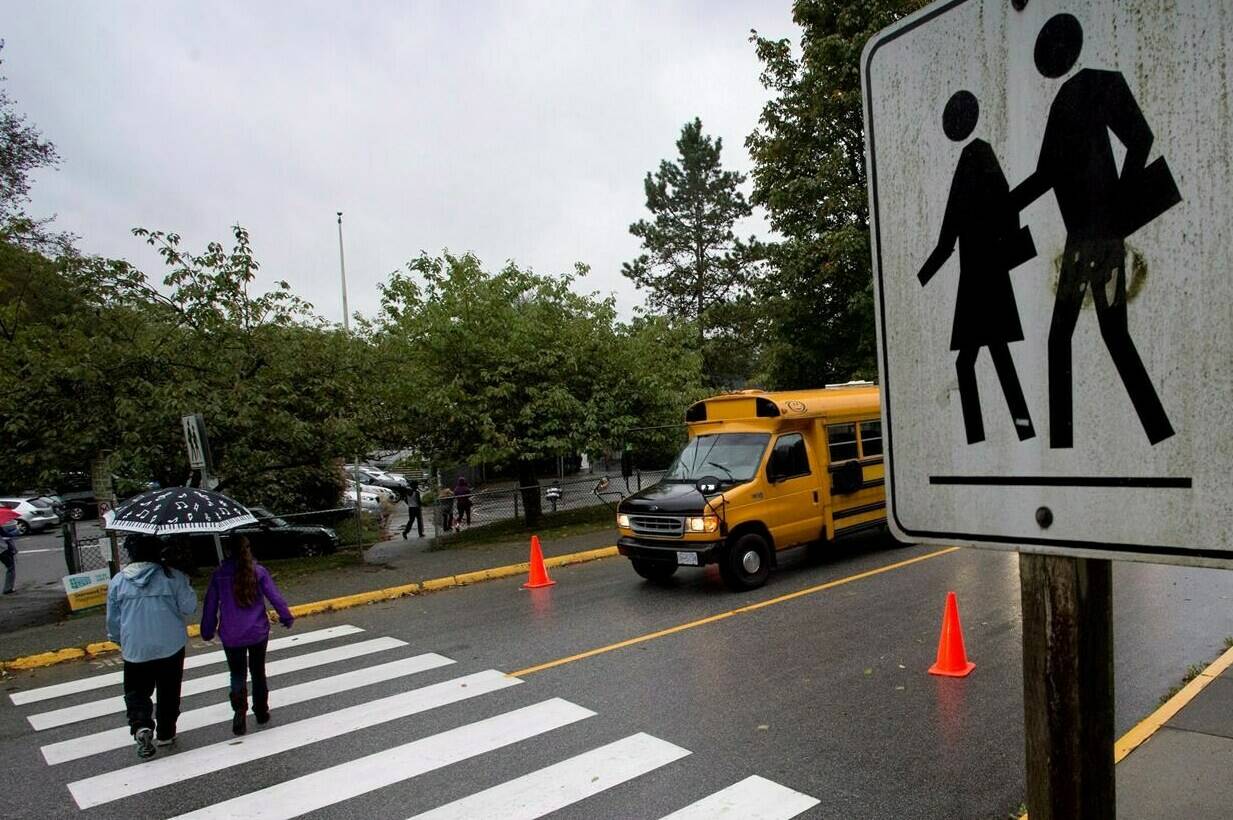 Students make their way to the first day of school at Sherwood Park Elementary in North Vancouver, Monday, Sept. 22, 2014. British Columbia’s public school teachers have ratified a new three-year contract. THE CANADIAN PRESS/Jonathan Hayward