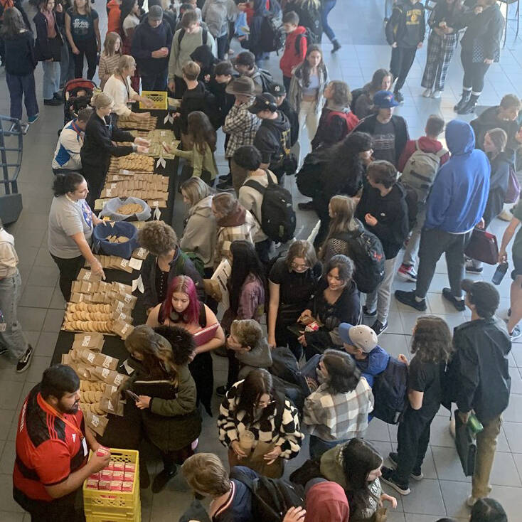Volunteers from the Oceanview Community Church hand out cookies to students and staff in the Ladysmith Secondary School foyer. (Photo submitted)