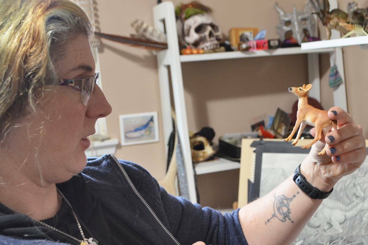 Creature artist and illustrator Karen Sim considers the shape and contour of a deer figurine in her Nanaimo studio, Nov. 25. (Mandy Moraes/News Bulletin)