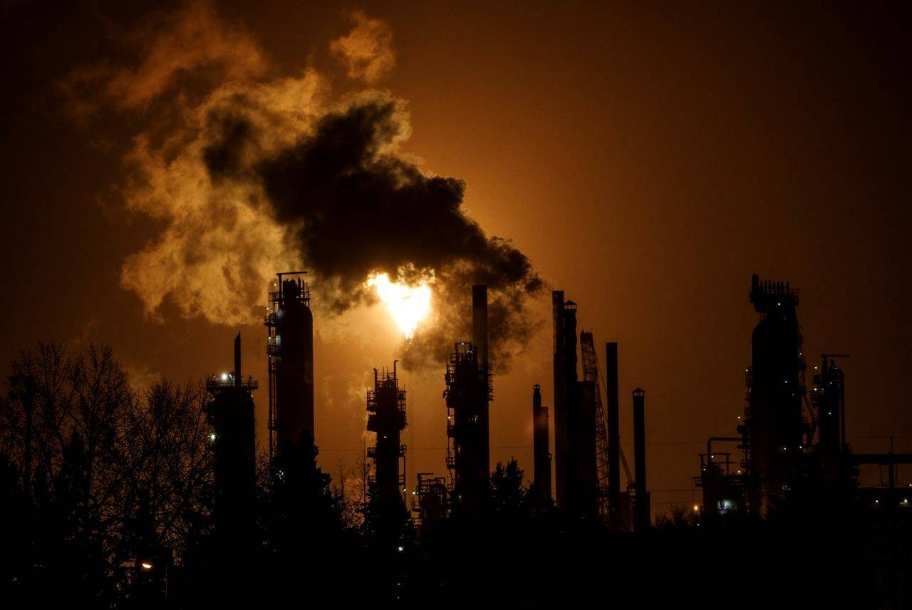 A flare stack lights the sky from the Imperial Oil refinery in Edmonton Alta, on Friday December 28, 2018. Canada has announced that it will end new direct subsidies for fossil fuel investments and projects abroad, including those owned by Canadian companies.THE CANADIAN PRESS/Jason Franson