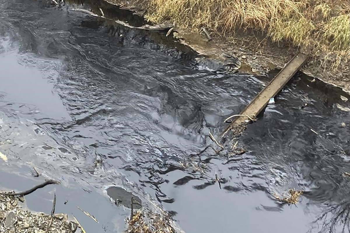 Oil from a Keystone pipeline rupture flows into Mill Creek in Washington County, Kansas, on Thursday, Dec 8, 2022. Vacuum trucks, booms and an emergency dam were constructed on the creek to intercept the spill. (Kyle Bauer/KCLY/KFRM Radio via AP)