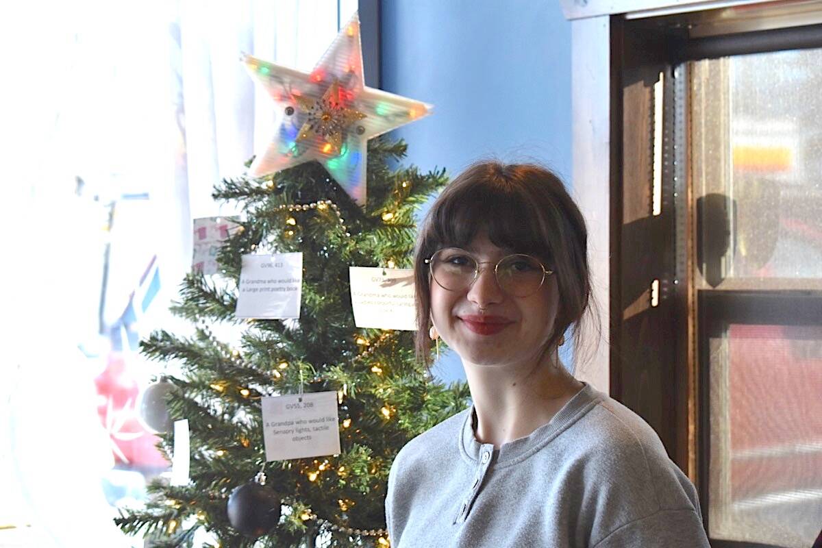 Adopt-a-Grandparent founder Breanna Brosko is pictured with the Christmas tree adorned with tags at Jo Klassen’s Restaurant in Courtenay. Scott Stanfield photo