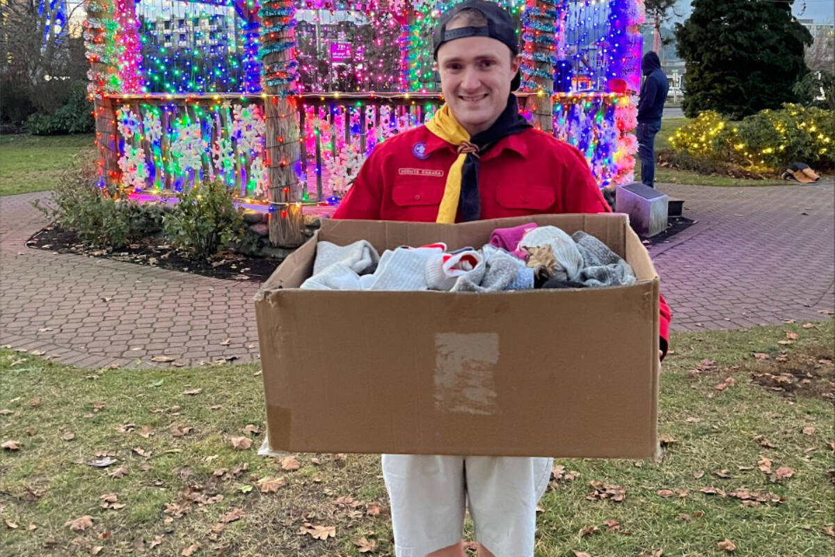 Markus Meyer, the group's Beaver Leader, holds a box of socks collected for the drive. (Courtesy of Sandra Meyer)