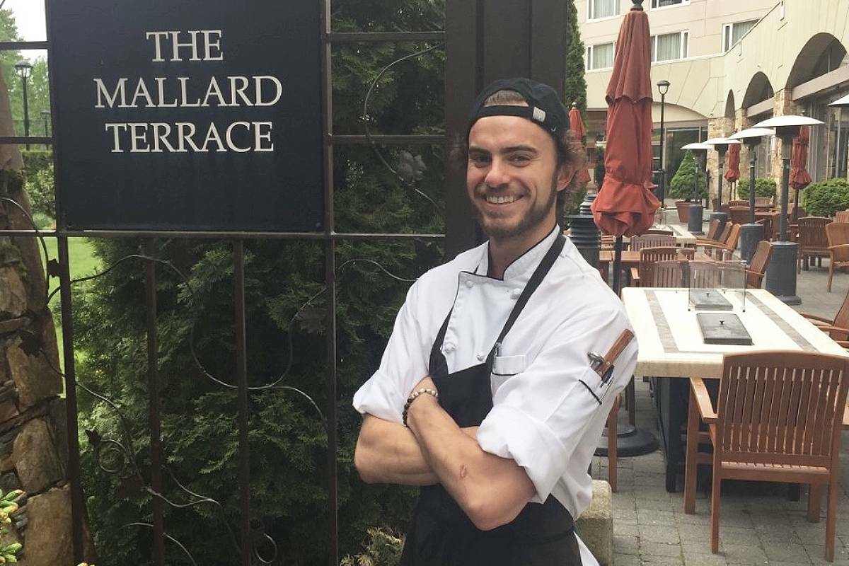 Matt McCamon, a Nanaimo TikTok content creator, stands in front of the Mallard Lounge at the Fairmont Chateau Whistler during his culinary apprenticeship. (Submitted photo)