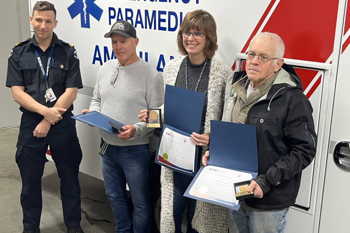 From left to right: paramedic MJ Brownlee presented Greg and Tina Valliere and Greg Slobodin with the Vital Link Award at the Denman Island paramedic station Dec. 13 during a special award ceremony. Photo by Erin Haluscchak