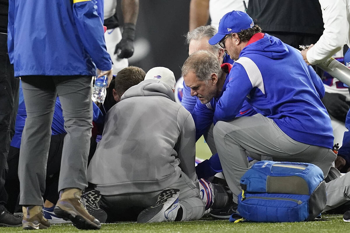 Buffalo Bills’ Damar Hamlin is examined during the first half of an NFL football game against the Cincinnati Bengals, Monday, Jan. 2, 2023, in Cincinnati. The game has been postponed, NFL Commissioner Roger Goodell announced. (AP Photo/Joshua A. Bickel)