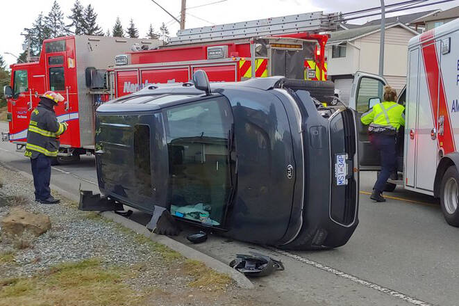 Crews say it appears an SUV collided with a traffic-calming barrier and tipped over on Lost Lake Road the morning of Wednesday, Jan. 4. (Chris Bush/News Bulletin)