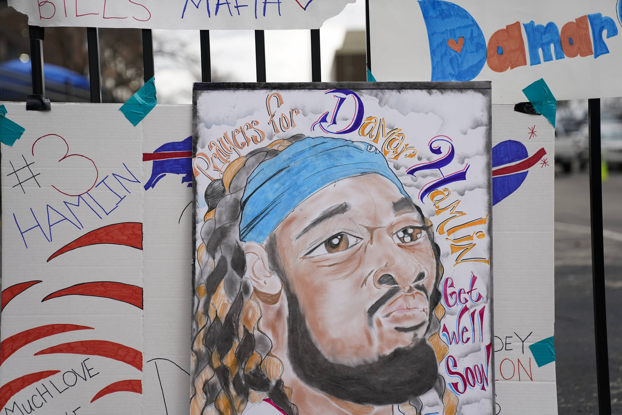 An artist’s portrait of Buffalo Bills safety Damar Hamlin is displayed outside UC Medical Center, where Hamlin remains hospitalized, Thursday, Jan. 5, 2023, in Cincinnati. Hamlin has shown what physicians treating him are calling “remarkable improvement over the last 24 hours,” the team announced on Thursday, three days after the player went into cardiac arrest and had to be resuscitated on the field. (AP Photo/Joshua A. Bickel)