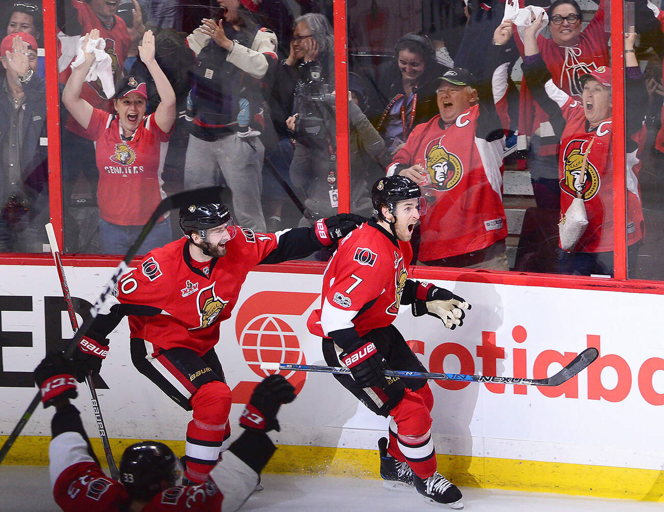 Ottawa Senators centre Kyle Turris (7) celebrates his game winning goal against the New York Rangers with teammates Fredrik Claesson (33) and Tom Pyatt (10) during the first overtime period in game five of a second-round NHL hockey Stanley Cup playoff series in Ottawa on Saturday, May 6, 2017. THE CANADIAN PRESS/Sean Kilpatrick