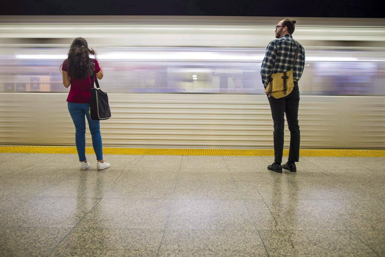 Commuters wait to take the subway at Ossington Station in Toronto on Friday, June 22, 2018. THE CANADIAN PRESS/ Tijana Martin