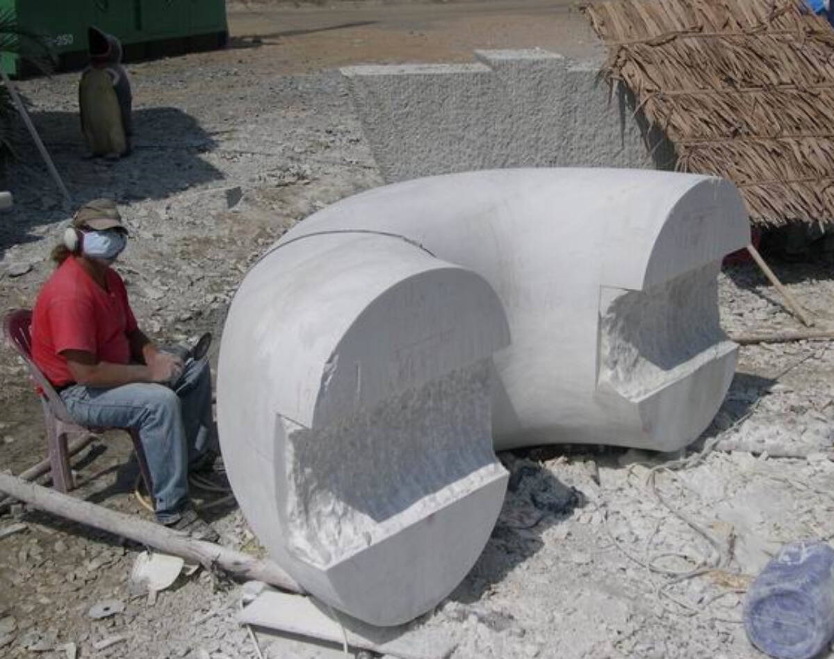 The final work is titled Your Thoughts Can Set you Free. Here seen in progress in Chou Doc, Vietnam, the final piece is 32 metric tons held together with mortise and tenon joints. This half circle piece is made of marble. (Photo courtesy of Jock Hildebrand)