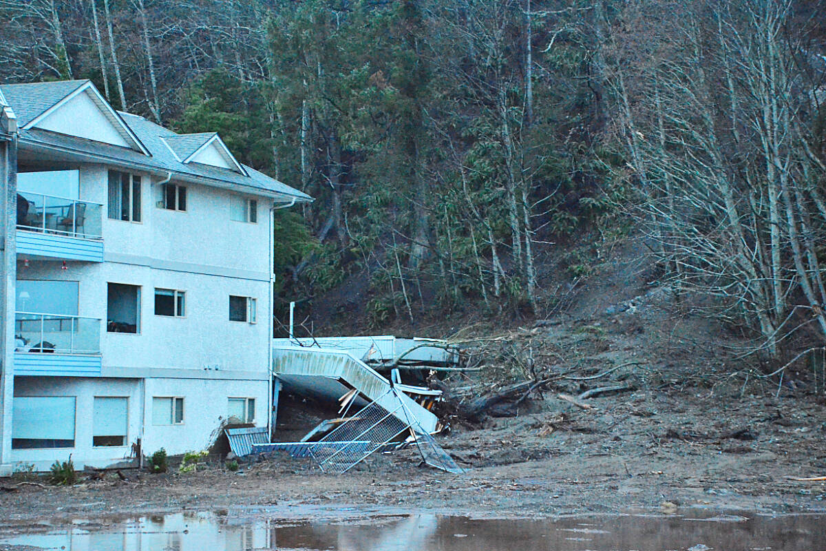 Roots, tree trunks and mud pile up against a parkade that collapsed in a mudslide at the 700 block of South Island Highway in Campbell River Tuesday, Jan. 17, 2023. Photo by Alistair Taylor/Campbell River Mirror