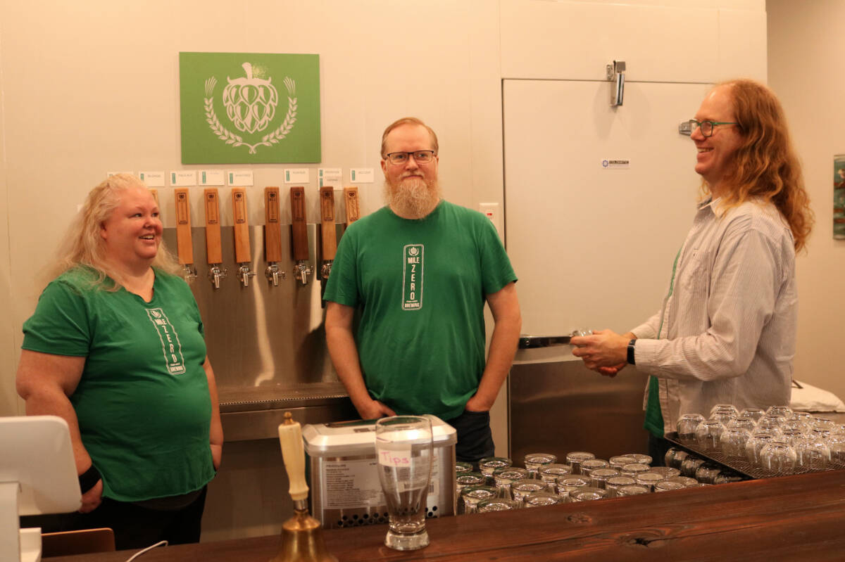 From left to right: co-owners Michelle Morgan, Michael Morgan and Dirk Slot behind the bar at Mile Zero Brewing in Metchosin. (Bailey Moreton/News Staff)