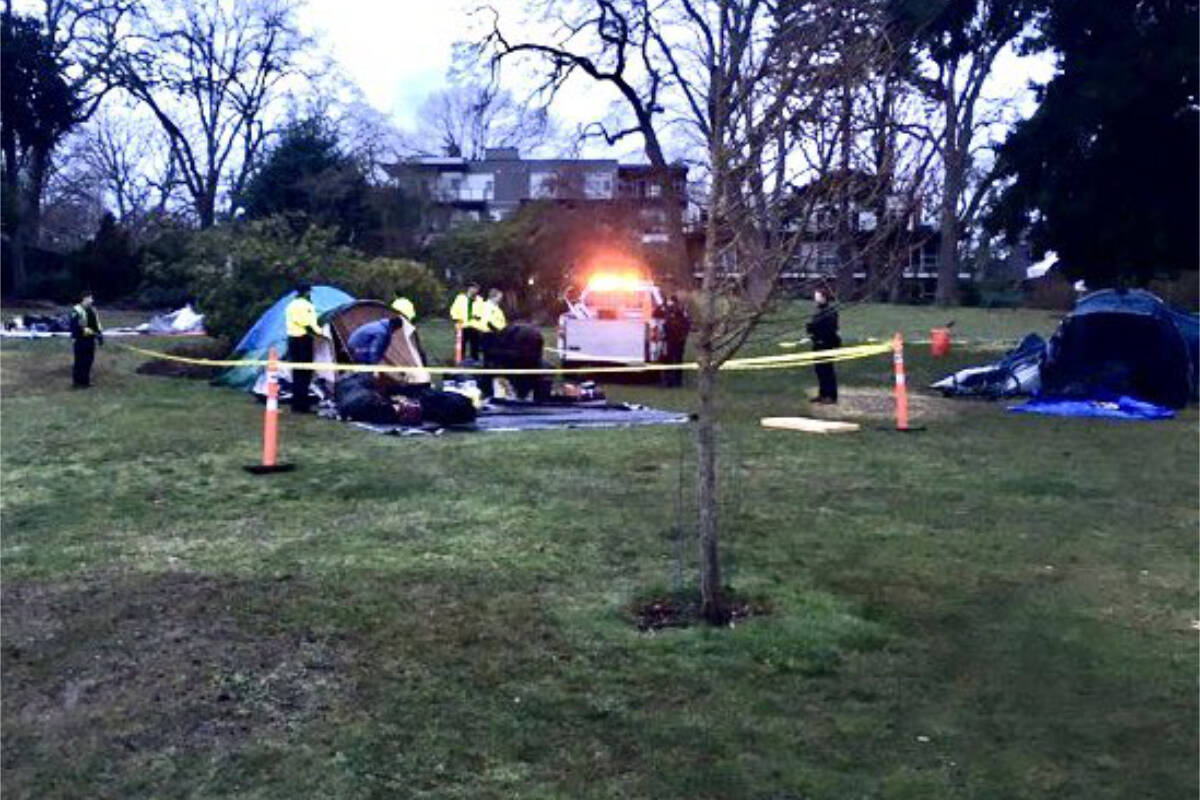 Bylaw officers removing personal belongings including tents and blankets from an encampment at Stradacona Park on Feb. 4 at 7:30 a.m. (Courtesy of Trent Smith)