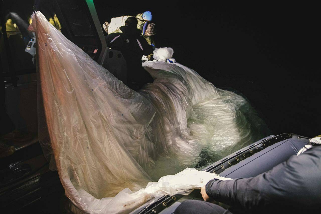 This image provided by the U.S. Navy shows sailors assigned to Explosive Ordnance Disposal Group 2 recovering a high-altitude surveillance balloon off the coast of Myrtle Beach, S.C., Feb. 5, 2023. Canada’s defence minister says the United States is still trying to determine whether China’s surveillance balloon collected any intelligence from either country when it was over North America last week. THE CANADIAN PRESS-U.S. Navy via AP *MANDATORY CREDIT*
