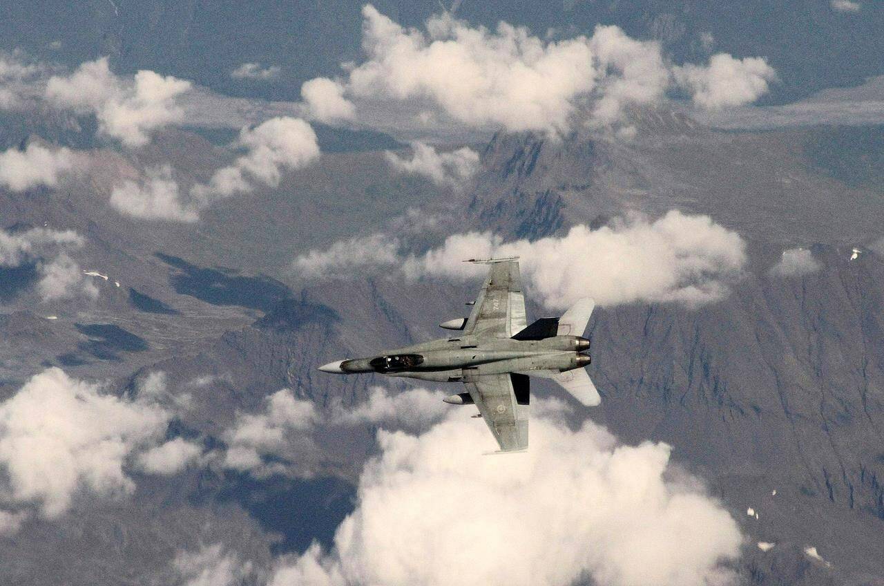 This photo made Tuesday, Aug. 27, 2013, shows a Canadian F-18 over western Alaska as it tracks a hijacked airplane in a simulation. The North American Aerospace Defence Command says it has positively identified an object that is currently flying at high altitude over Northern Canada. THE CANADIAN PRESS/AP/Mark Thiessen