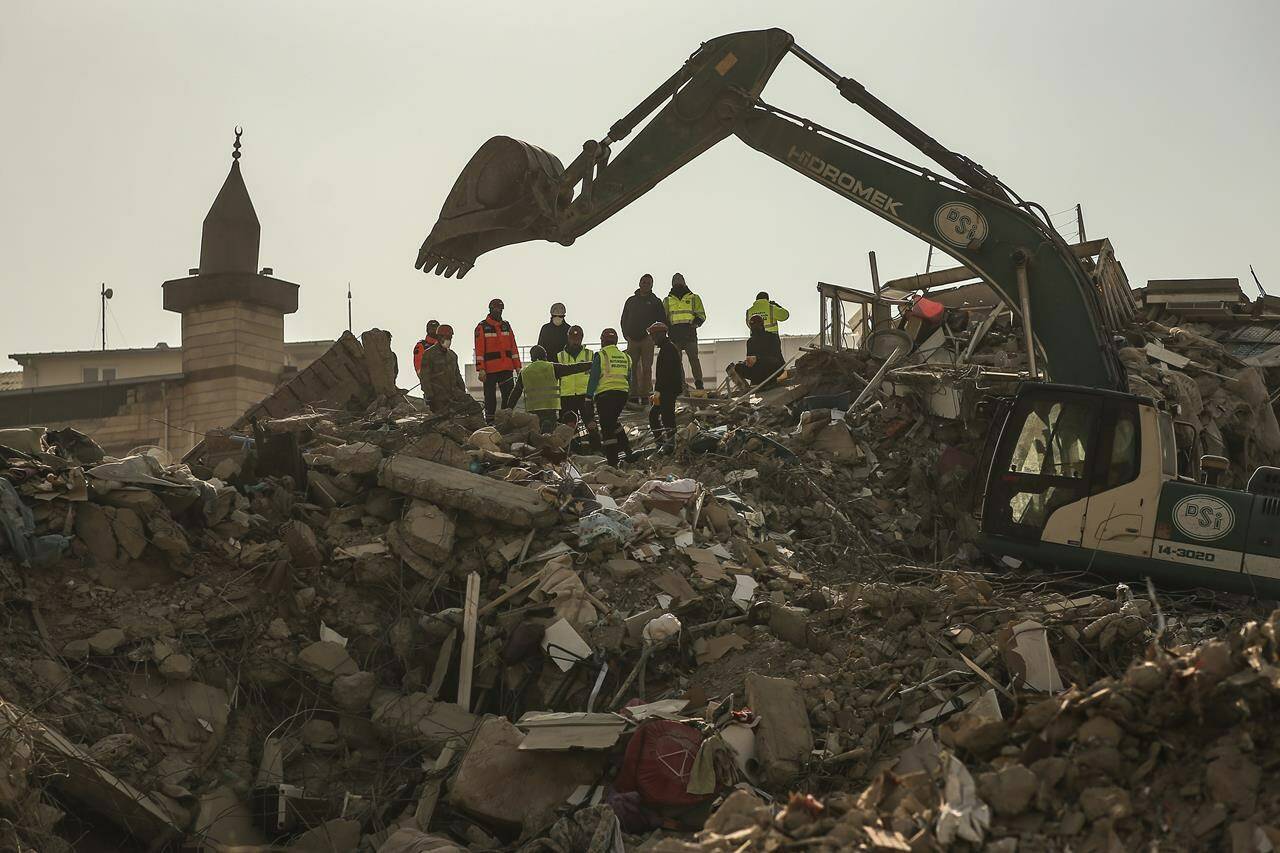 Rescuers work on a collapsed building in Kahramanmaras, southern Turkey, Sunday, Feb. 12, 2023. Six days after earthquakes in Syria and Turkey killed tens of thousands, sorrow and disbelief are turning to anger and tension over a sense that there has been an ineffective, unfair and disproportionate response to the historic disaster. (AP Photo/Emrah Gurel)