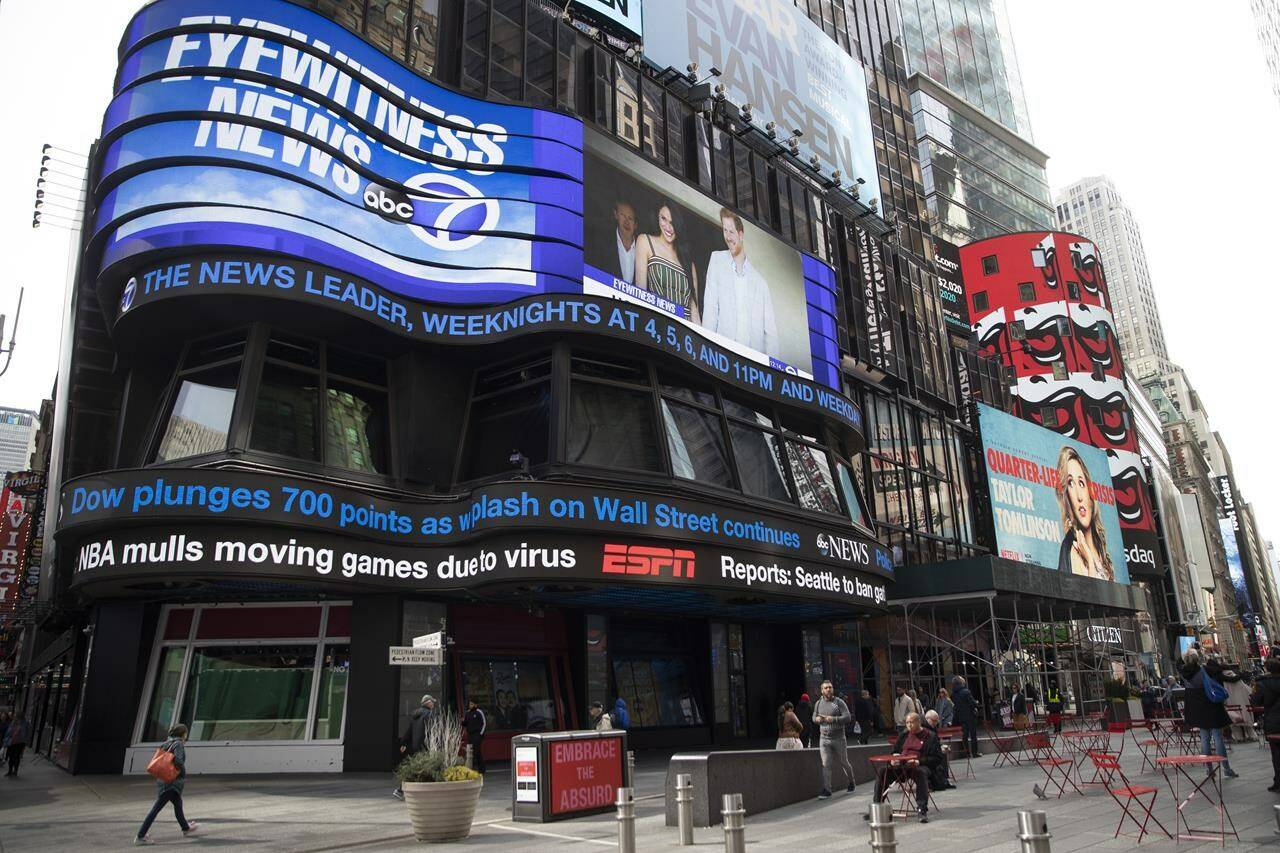 FILE - An electronic ticker displays news Wednesday, March 11, 2020, in New York’s Times Square. A new survey released Wednesday, Feb. 15, 2023, shows fully half of Americans indicate they believe national news organizations intend to mislead, misinform or persuade the public to adopt a point of view. (AP Photo/Mary Altaffer, File)