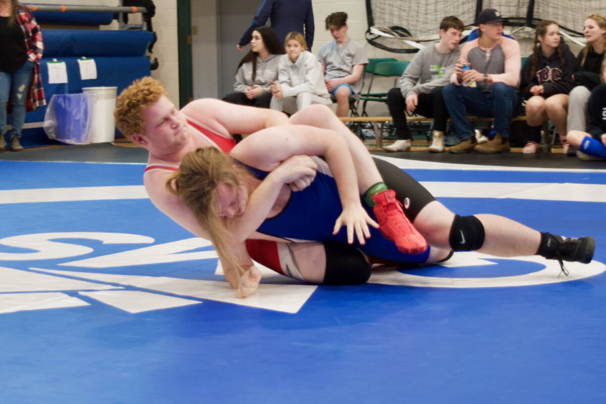 Grant Coulthart (in red) grapples with an opponent during the Vancouver Island Secondary School Wrestling Championships. Coulthart ended up winning gold in the 110-kg category. (SUBMITTED PHOTO)