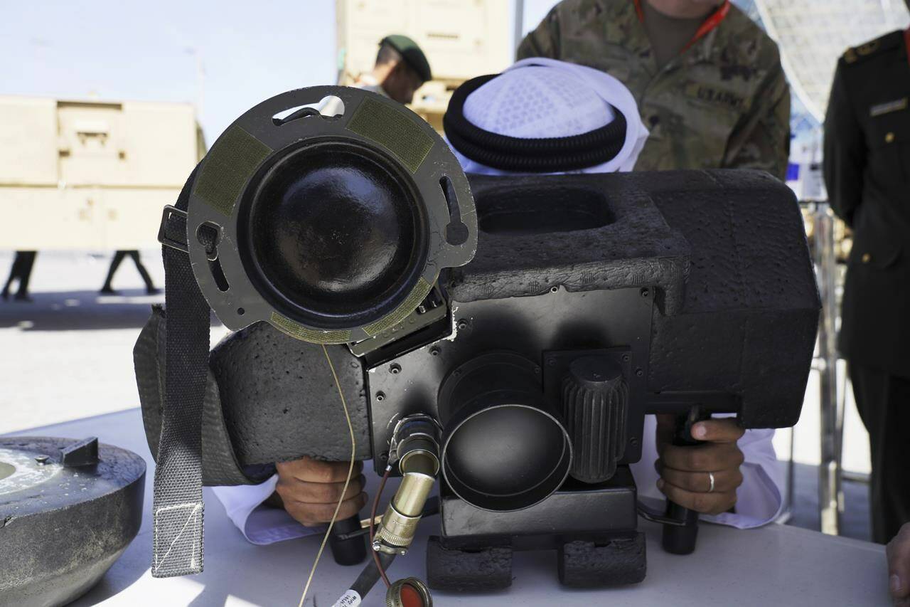 An Emirati tries a Javelin anti-tank weapon simulator at the International Defense Exhibition and Conference in Abu Dhabi, United Arab Emirates, Monday, Feb. 20, 2023. Just outside of Abu Dhabi’s biennial arms fair in a large tent, Russia offered weapons for sale Monday ranging from Kalashnikov assault rifles to missile systems despite facing sanctions from the West over its war on Ukraine. (AP Photo/Jon Gambrell)