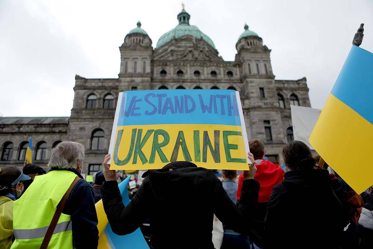 Hundreds of people gathered in solidarity for the people of Ukraine on the steps of the legislature in Victoria in a February 2022 rally. A candlelight vigil Feb. 24 at 6 p.m. behind the legislature marks the one-year anniversary of the invasion. (THE CANADIAN PRESS/Chad Hipolito)