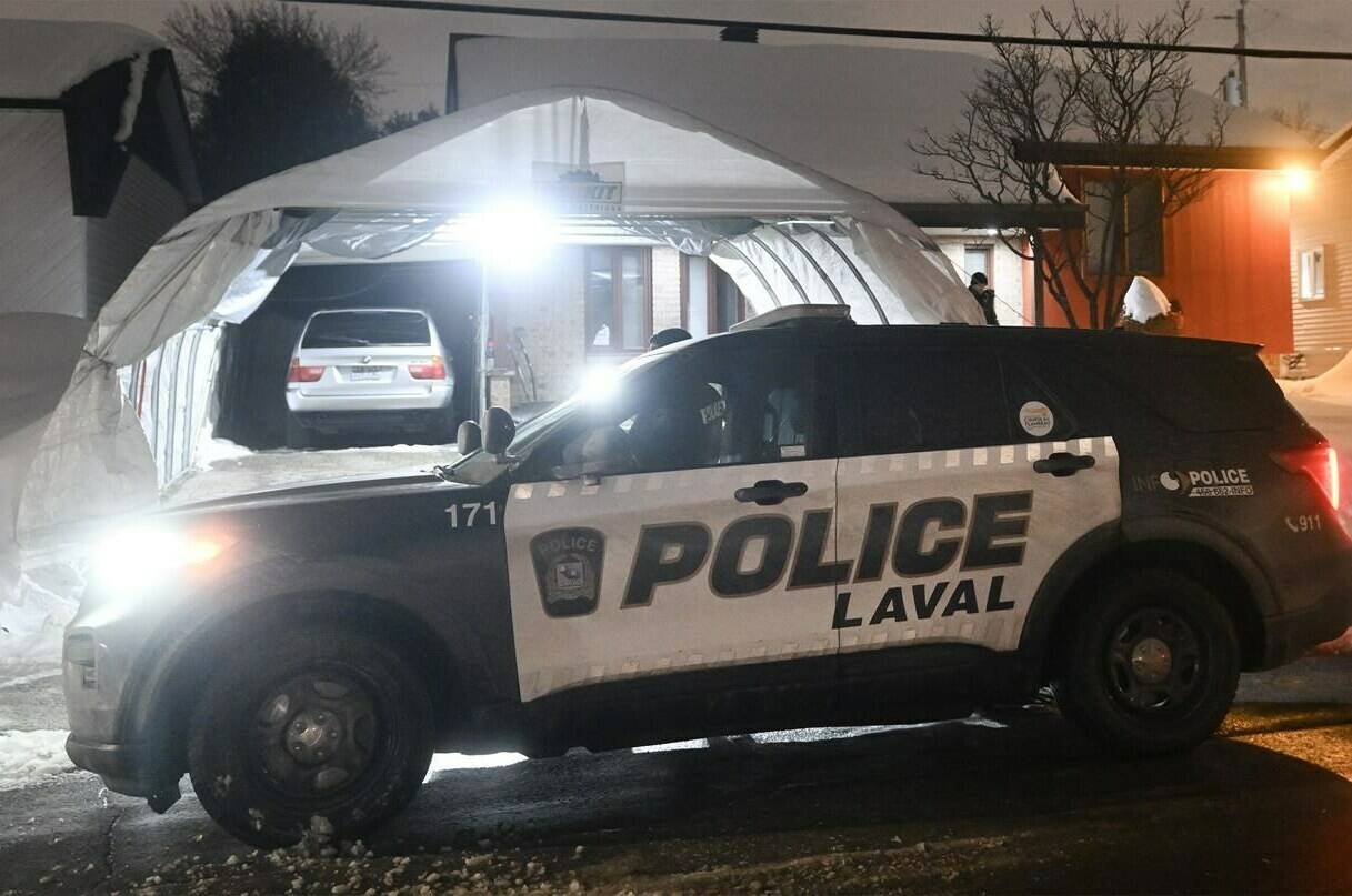 Police are shown outside the home of Pierre Ny St-Amand in Laval, Que., Wednesday, Feb. 8, 2023. The man accused of killing two young children when the bus he was driving slammed into a suburban daycare will undergo a further evaluation to determine his criminal responsibility. Pierre Ny St-Amand made an appearance today in a courtroom in Laval, just north of Montreal. THE CANADIAN PRESS/Graham Hughes
