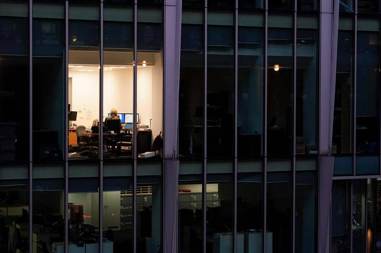 While salary negotiations are a normal part of the hiring process, experts say it’s a stone often left unturned by young candidates unsure of how to ask for more money from an employer. A worker sits in an office in the financial district in London, Monday, Dec. 13, 2021. THE CANADIAN PRESS/AP-Alberto Pezzali