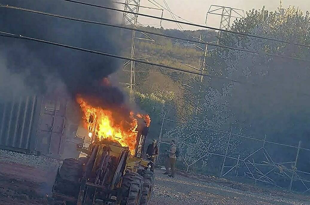 This image provided by the Atlanta Police Department shows construction equipment set on fire Saturday, March 4, 2023 by a group protesting the planned public safety training center, according to police. (Atlanta Police Department via AP)