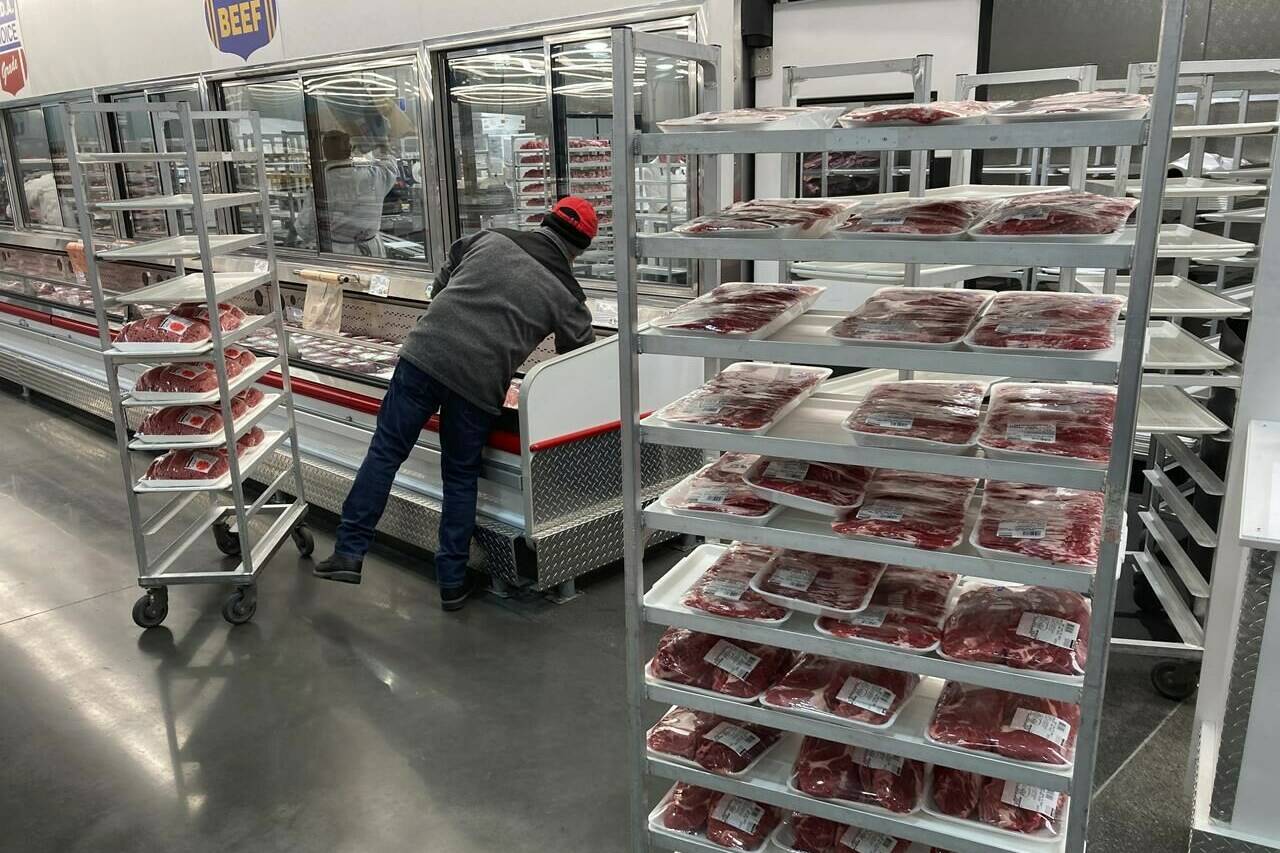 FILE - An employee restocks meats on Jan. 17, 2023, in North Miami, Fla. Greenhouse gas emissions from the way humans consume food could add nearly one degree of warming to the Earth’s climate by 2100, according to a new study Monday, March 6, 2023. Researchers found that the majority of greenhouse gas emissions come from three major food groups — meat from animals like cows, sheep and goats, dairy and rice. (AP Photo/Wilfredo Lee, File)