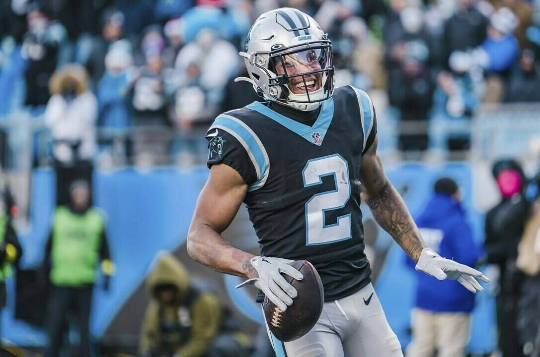 FILE - Carolina Panthers wide receiver DJ Moore (2) reacts after scoring a touchdown during an NFL football game between the Carolina Panthers and the Detroit Lions on Saturday, Dec. 24, 2022, in Charlotte, N.C. The Panthers have traded up to acquire the No. 1 overall pick in the draft from the Chicago Bears in exchange for Carolina's No. 9 and No. 61 overall picks in 2023, a first-round pick in 2024, a second-round pick in 2025 and star wide receiver D.J. Moore, two people familiar with the deal said Friday, March 10, 2023, The people spoke to The Associated Press on condition of anonymity because the trade had not been announced. (AP Photo/Jacob Kupferman, File)
