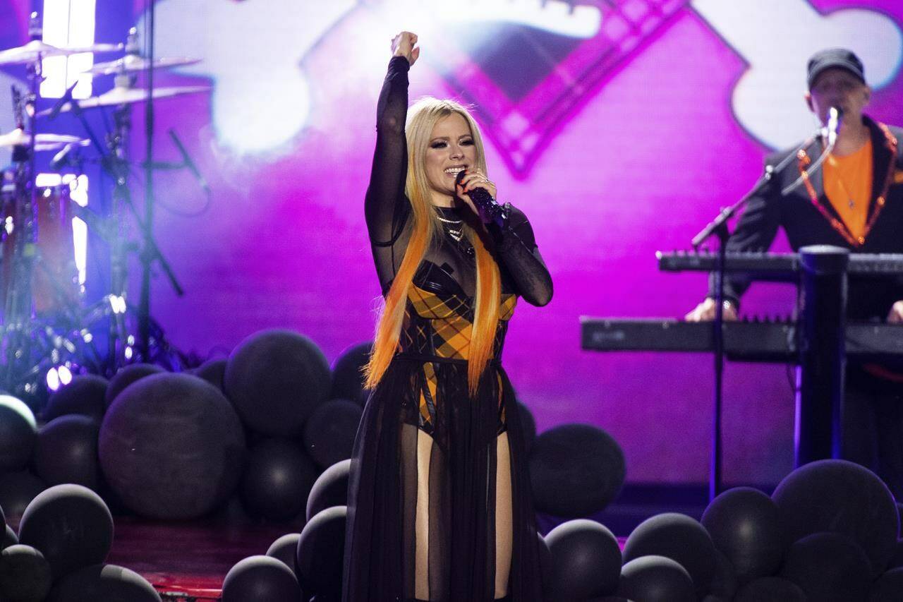 More than 40 categories will be handed out at the Juno Opening Night Awards ceremony which takes place at the Edmonton Convention Centre, co-hosted by “Run the Burbs” star Andrew Phung and CBC Music’s Angeline Tetteh-Wayoe. Avril Lavigne performs on stage at the JUNO Awards on Sunday, May 15, 2022, at the Budweiser Stage in Toronto. THE CANADIAN PRESS/Arthur Mola-Invision-AP
