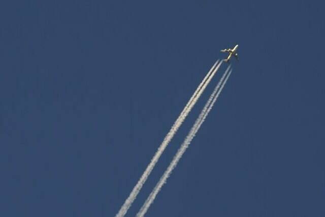 An airliner cuts through the skies over Montreal, Wednesday, Dec. 23, 2020. An aviation expert says the seizure of four Flair Airlines planes over the weekend points to the fierce competition and high demand playing out in the Canadian air travel industry. THE CANADIAN PRESS/Paul Chiasson