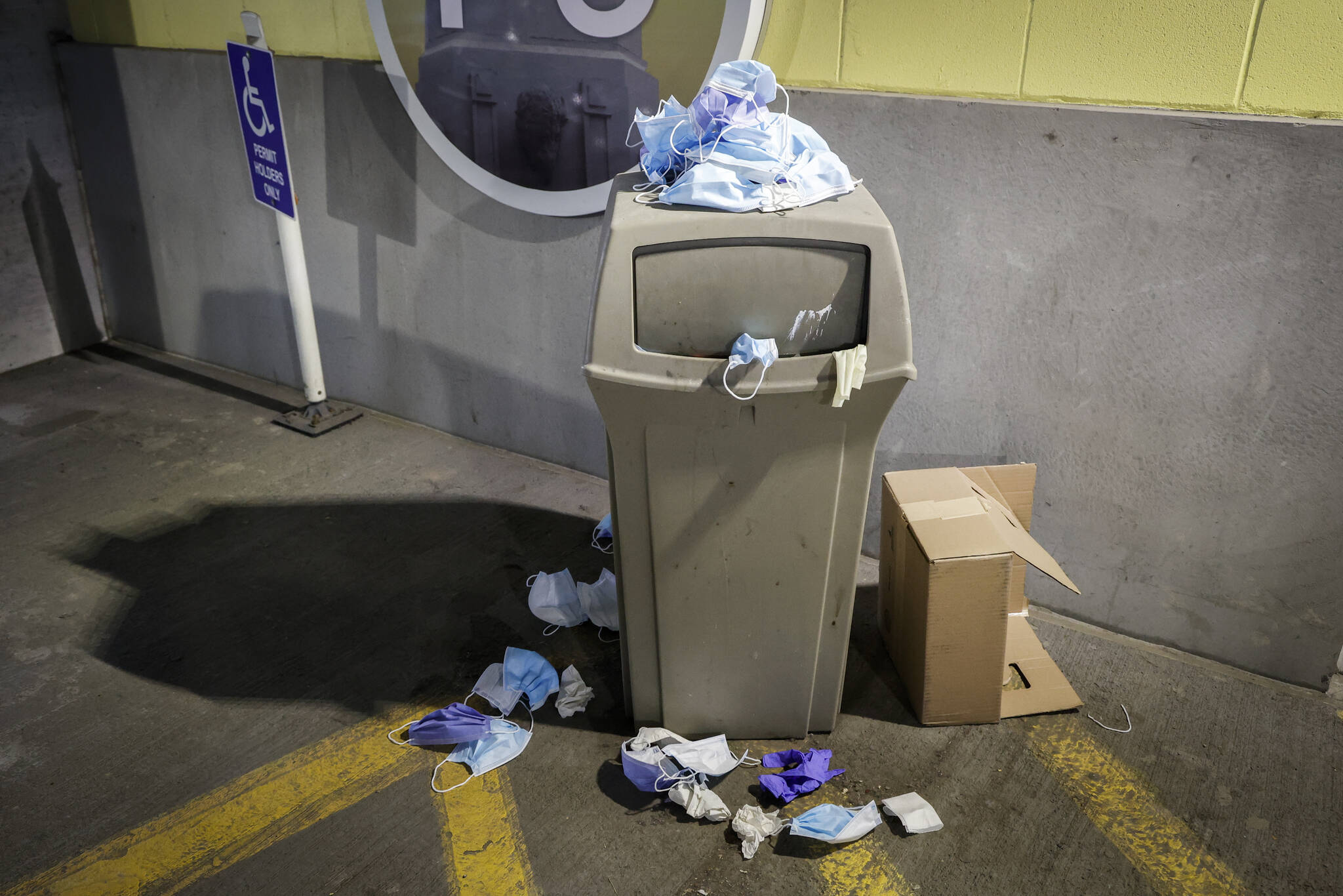 Used medical masks overflow a waste bin at the University of Calgary Medical Clinics in Calgary, Alta., Thursday, Nov. 17, 2022.THE CANADIAN PRESS/Jeff McIntosh