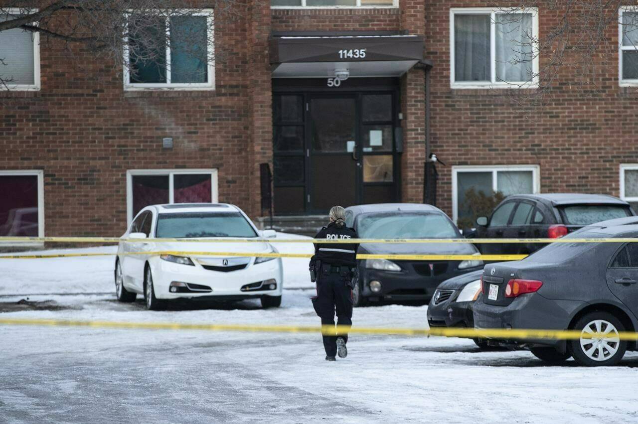 Police investigate the scene where two officers were shot and killed on duty in Edmonton on Thursday, March 16, 2023. THE CANADIAN PRESS/Jason Franson