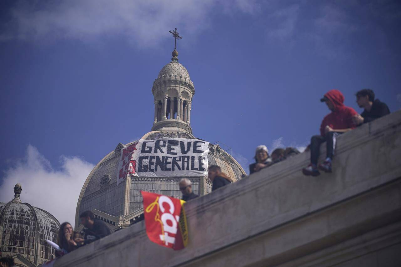 A banner is fixed on the Cathedral of Sainte-Marie Major that reads, “general strike,” during a rally in Marseille, southern France, Thursday, march 23, 2023. French unions are holding their first mass demonstrations Thursday since President Emmanuel Macron enflamed public anger by forcing a higher retirement age through parliament without a vote. (AP Photo/Daniel Cole)